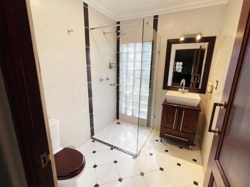 a bathroom with a shower and a sink at Village Ridge Boutique Stays in Pretoria