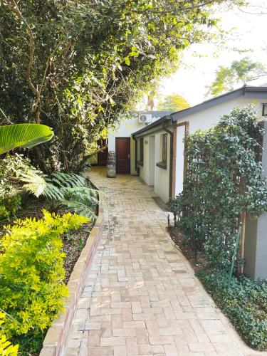 a brick walkway in front of a house at Village Ridge Boutique Stays in Pretoria