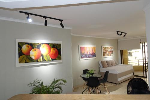 a living room with a bed and a painting on the wall at Cabrero Beach 1111 in Cartagena de Indias
