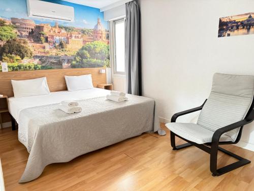 a bedroom with a bed and a chair and a window at Hostal Zaragoza Centro in Zaragoza