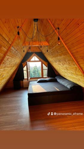a bedroom with a bed in a tent at Cabană Panoramic Aframe in Dealu Negru