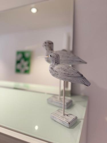 a bird statue sitting on a shelf in a display case at Villa19hundert5 moderne Ferienwohnungen in zentraler Lage in Lindenberg im Allgäu