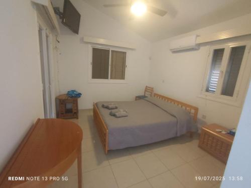 a bedroom with a bed in a white room at 3-Bedroom House Near the Beach in Paralimni
