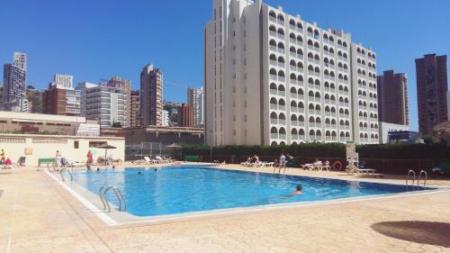 a large swimming pool in the middle of a city at Apartamentos Acuarium II in Benidorm