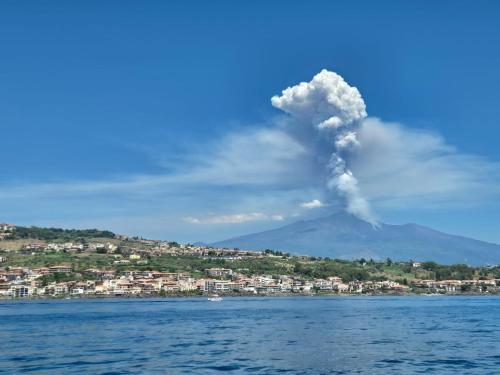 a plume of smoke coming out of a mountain at Casa Ludovica in Catania