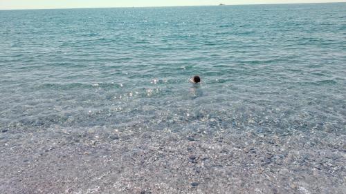 a person swimming in a body of water at Casa Ludovica in Catania