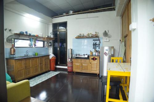 a kitchen with a sink and a refrigerator at Budget Stay in Imphal