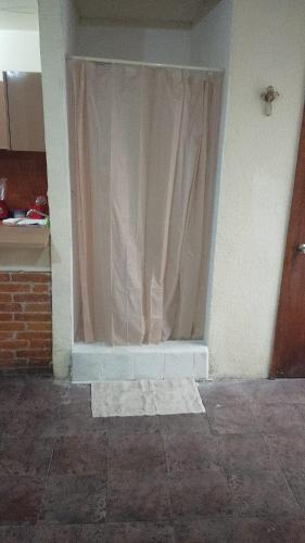 a window with a curtain in a room at Departamento C-3 in Mexico City