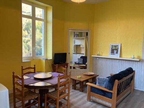 a living room with a table and a dining room at Cosy and bright apartment in Eaux-Bonnes center in Eaux-Bonnes