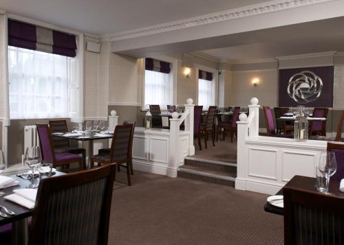 a restaurant with tables and chairs and a bar at Aston Hall Hotel, BW Signature Collection in Sheffield