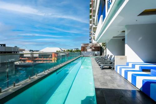 a swimming pool on the roof of a building at The Perfect Location Gym, Pool & Parking M22 in Brisbane