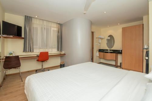 a bedroom with a large white bed and a desk at Best Western Nairobi Upper Hill in Nairobi