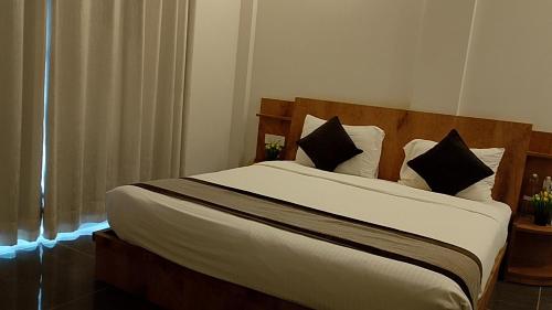 a bedroom with a large bed with white sheets and pillows at Rankk Stays in Arambol