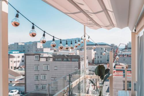a balcony with lights and a view of a city at Gridt Hotel & Home in Gyeongju