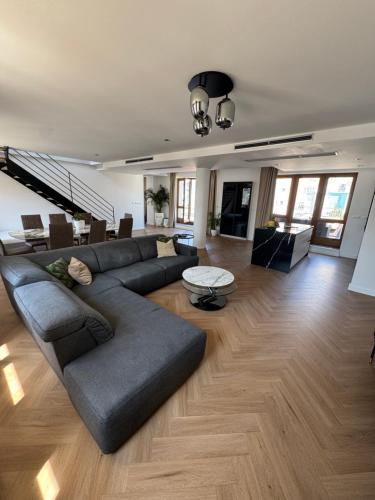 a living room with a couch and a table at Luxury PENTHOUSE at the Historical Centre Parking in Bratislava