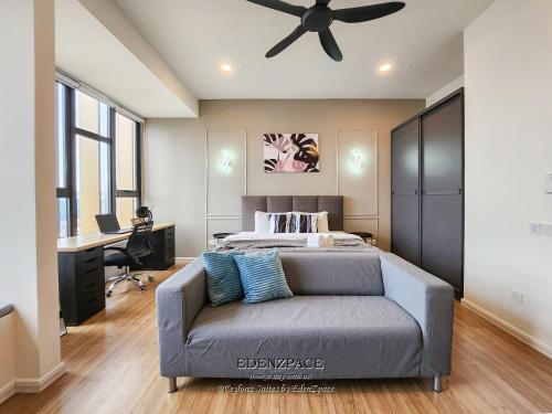 a bedroom with a bed and a couch and a desk at Ceylonz Suites by EdenZpace in Kuala Lumpur