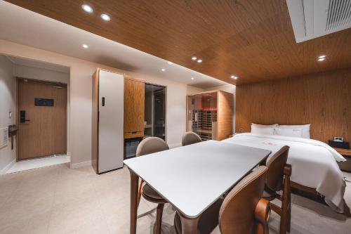 a bedroom with a bed and a table and chairs at Gridt Hotel & Home in Gyeongju