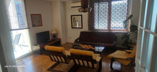 a living room with a couch and a table and chairs at Risto Apartment in Skopje