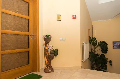 a room with a door with a vase of flowers at Кімнати в центрі in Uzhhorod