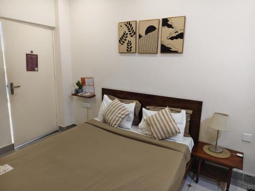 a bedroom with a large bed with pillows at Casa Mel in Puducherry