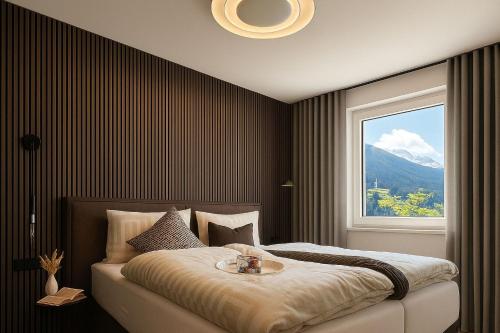 a bedroom with a bed with a table on it at Lynett Suites in Fliess