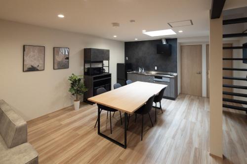 a kitchen and dining room with a table and chairs at Soyogi Stay in Takayama