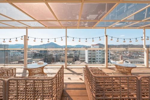a balcony with chairs and a view of a city at Gridt Hotel & Home in Gyeongju