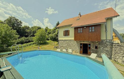 a swimming pool in front of a house at House Toni by Villas Guide in Brod Moravice