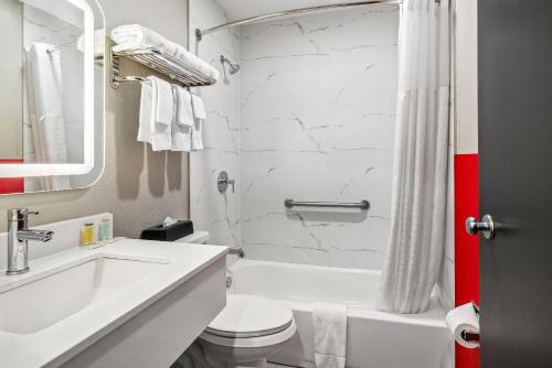 a white bathroom with a sink and a toilet at Super 8 by Wyndham Lewiston Auburn Area in Lewiston