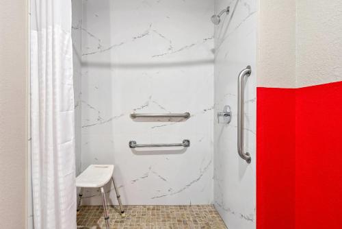 a bathroom with a red and white wall at Super 8 by Wyndham Lewiston Auburn Area in Lewiston