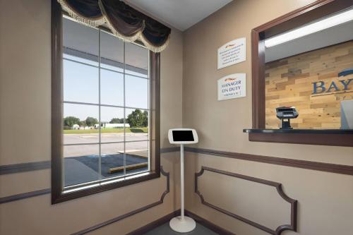 a waiting room with a window and a barber shop at Baymont by Wyndham Commerce GA Near Tanger Outlets Mall in Commerce