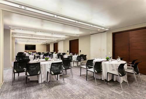 a conference room with white tables and black chairs at Hyatt Centric Times Square New York in New York
