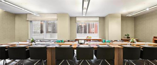a large conference room with a large table and chairs at Hyatt Centric Times Square New York in New York