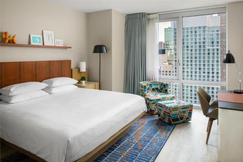 a hotel room with a bed and a large window at Hyatt Centric Times Square New York in New York
