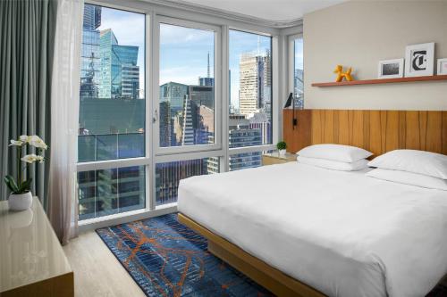 a bedroom with a large bed and a large window at Hyatt Centric Times Square New York in New York