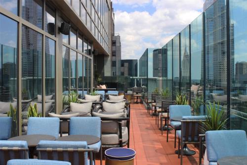 a row of chairs and tables on a building balcony at Hyatt Centric Times Square New York in New York