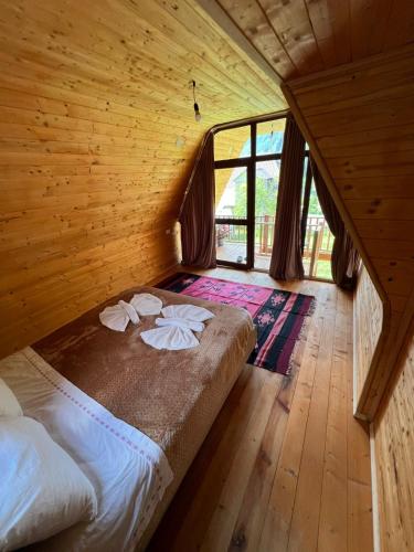 a bedroom with a bed in a wooden room at Villa Belinis in Theth