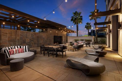 a patio with tables and chairs and a fireplace at Hampton Inn & Suites - Napa, CA in Napa
