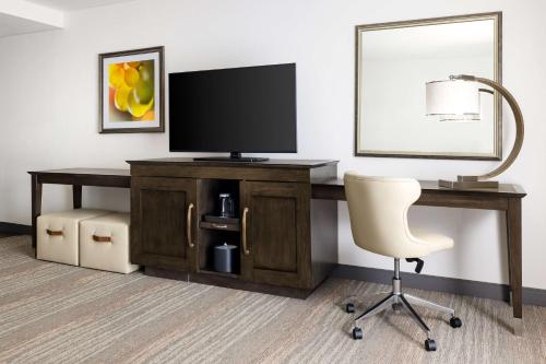 a desk with a television and a chair in a room at Hampton Inn & Suites - Napa, CA in Napa