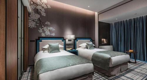 a hotel room with two beds in a room at International Conference Hotel Nanjing in Nanjing