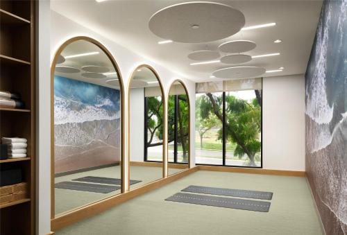 a meditation room with large windows and meditation mats at Hotel Zessa Orange County Airport, a DoubleTree by Hilton in Santa Ana