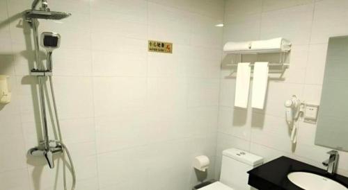 a white bathroom with a toilet and a sink at shenzhen kaixin Hotel in Shenzhen