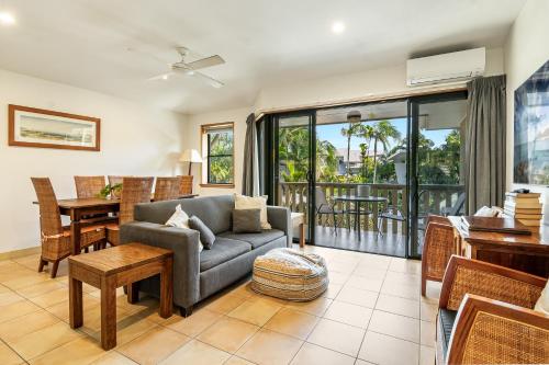 a living room with a couch and a table at The Crest Byron Bay in Byron Bay