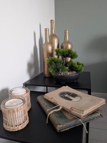 a table with wine bottles and baskets on it at La Maison d'Arlette - Maison d'Hôte et Gite au coeur de l'Isère à 10 mn de Voiron, capitale de la Chartreuse, et du Lac de Paladru in Saint-Blaise-du-Buis