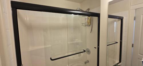 a shower with a glass door in a bathroom at Guest Suite in Langford Victoria in Victoria