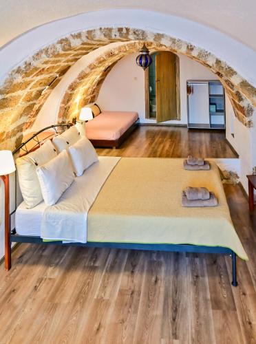 a bedroom with a large bed in front of an archway at Pablito House-Seaview Monemvasia Nests in Monemvasia