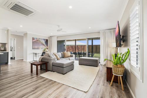 a living room with a couch and a table at Whitewash House in Bargara