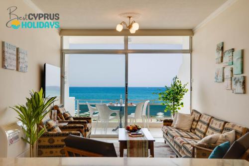 a living room with a view of the ocean at Makenzy Sandy Beachfront Paradise in Larnaca
