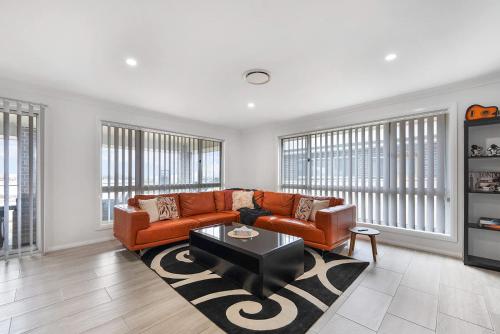 a living room with a couch and a table at Ignatius Retreat - Family Entertainer, Serene View in Kelso
