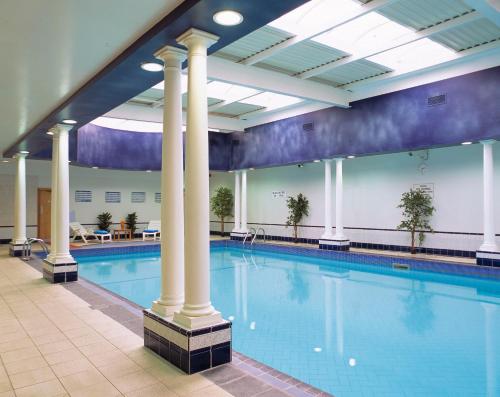 a swimming pool with columns in a building at Brandon Hotel Conference & Leisure Centre in Tralee